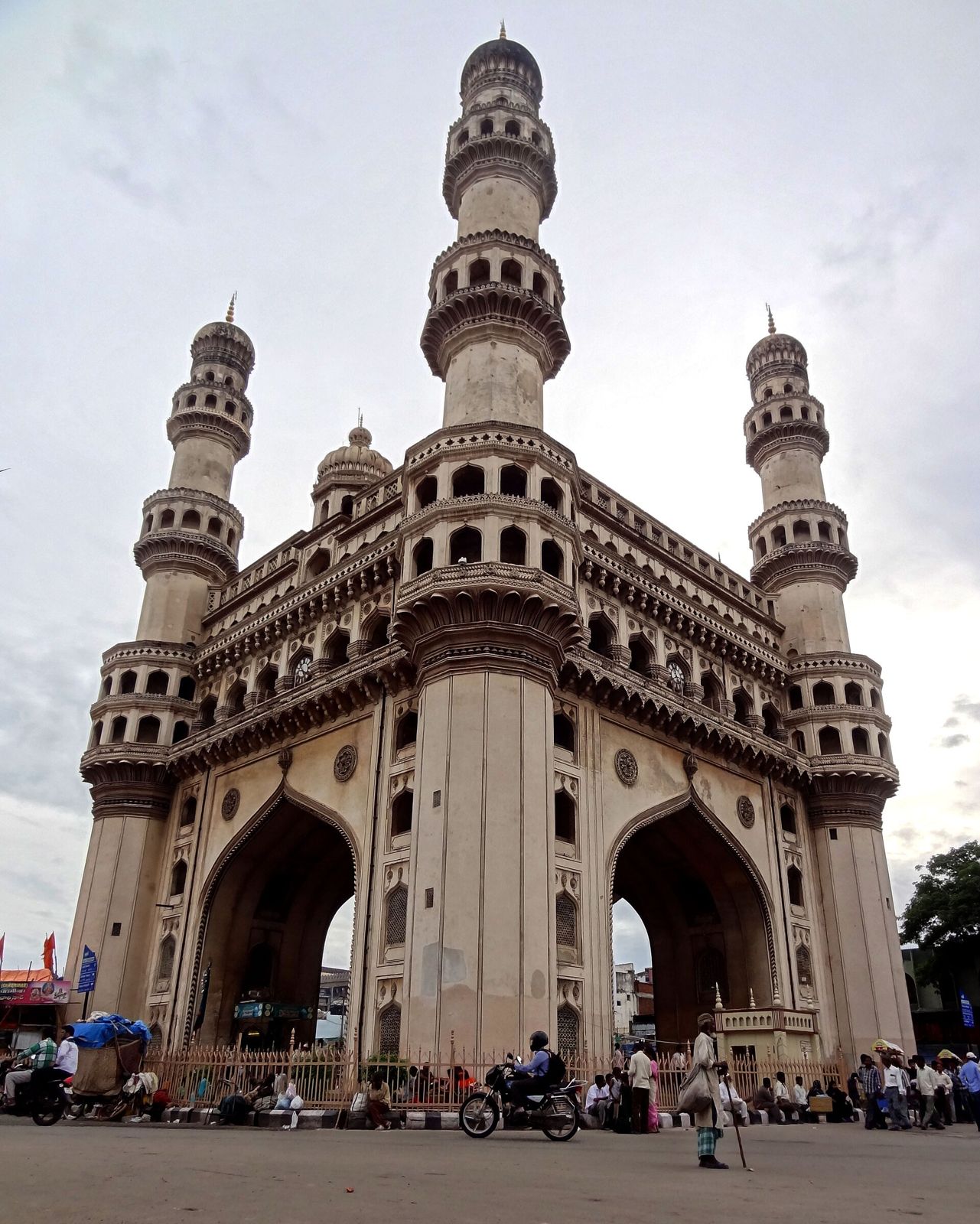 The Charminar from below at dusk, with the evening traffic around it