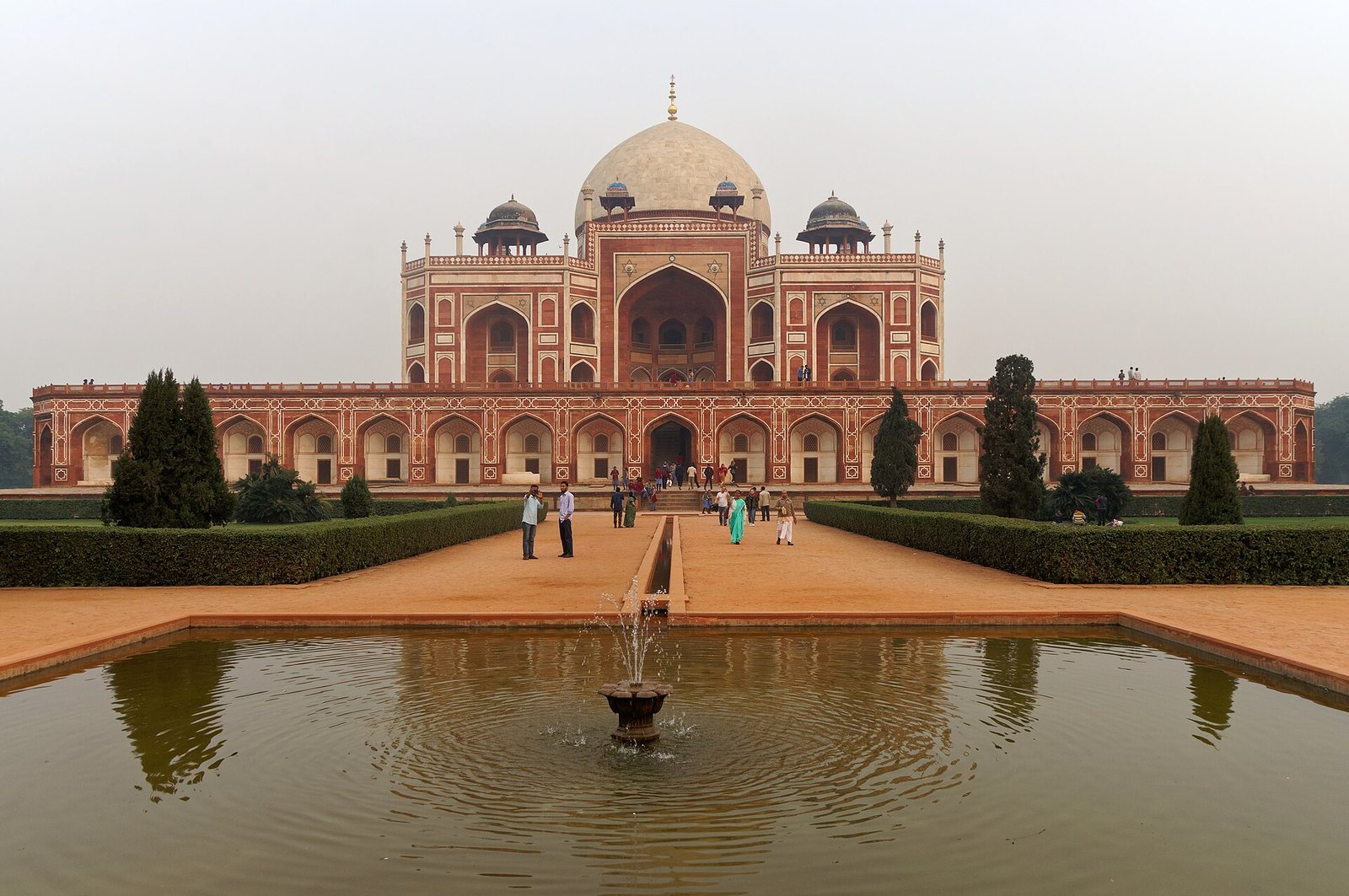 Humayun’s Tomb in Delhi, its red sandstone and marble dome reflected in a garden pool