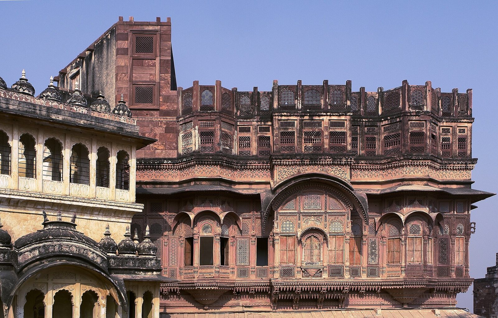 The carved sandstone palaces of Mehrangarh Fort in Jodhpur under a blue sky